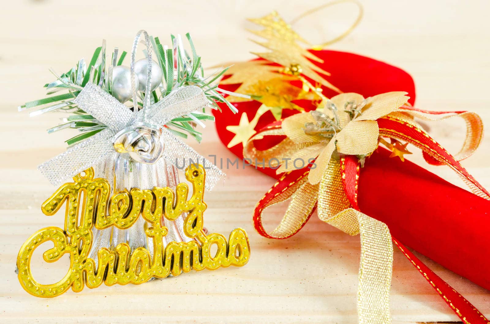 Merry Christmas on wooden background. by Gamjai