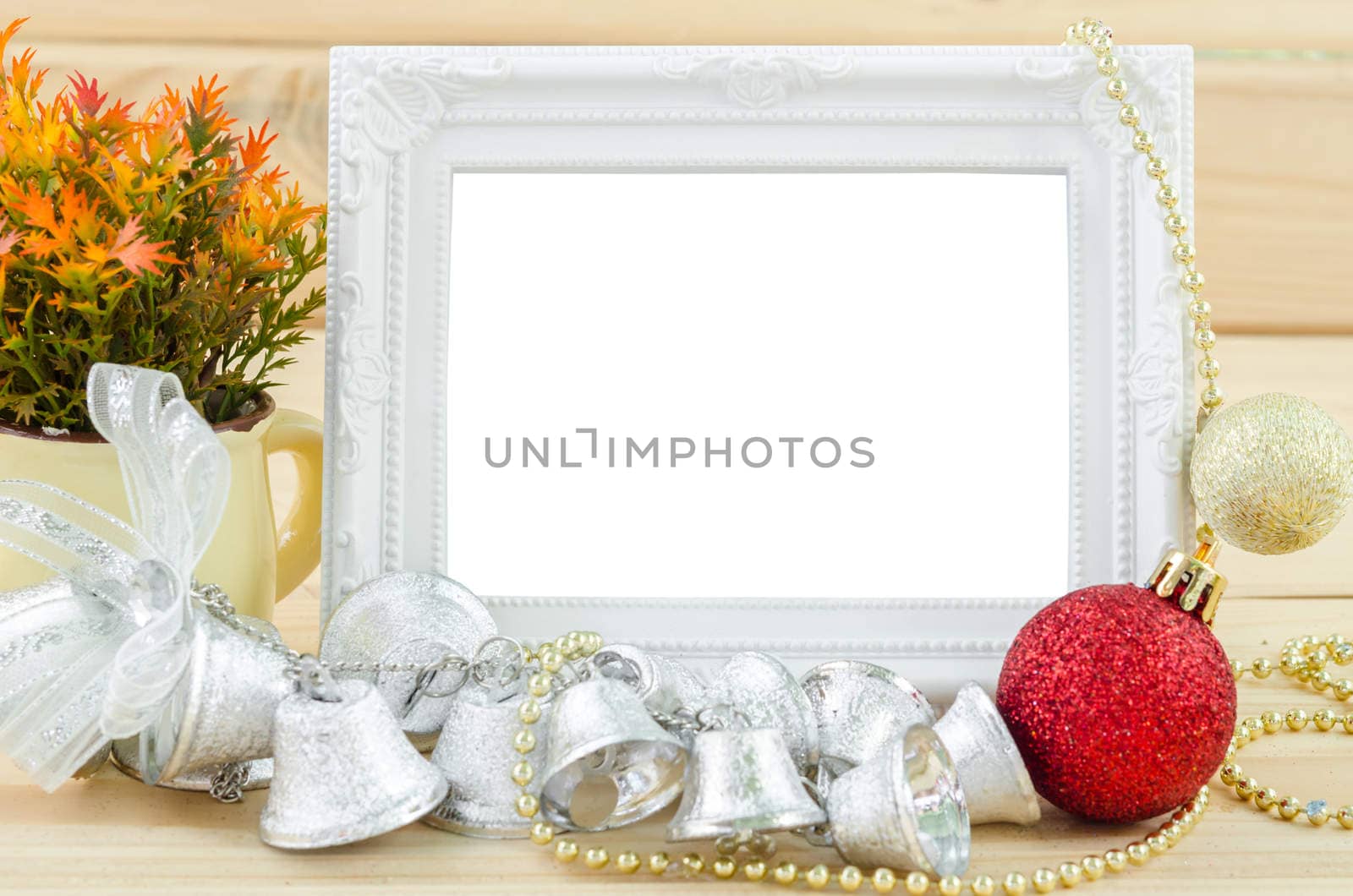Vintage white blankk photo frame with chirstmas decorations on wood background. Save clipping path.