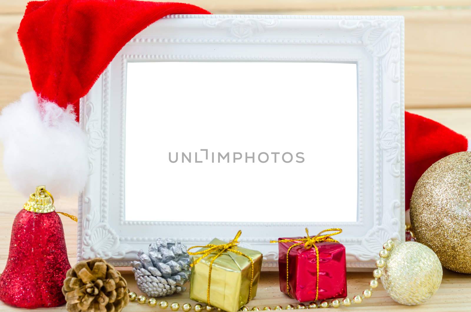 Vintage photo frame and christmas decorations on wood background. Save clipping path.