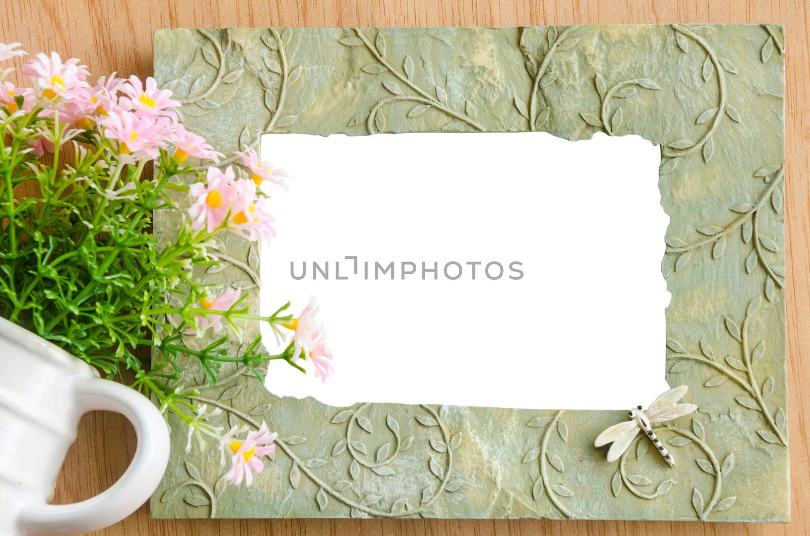 Blank photo frame and pink flower on wooden background. save clipping path.