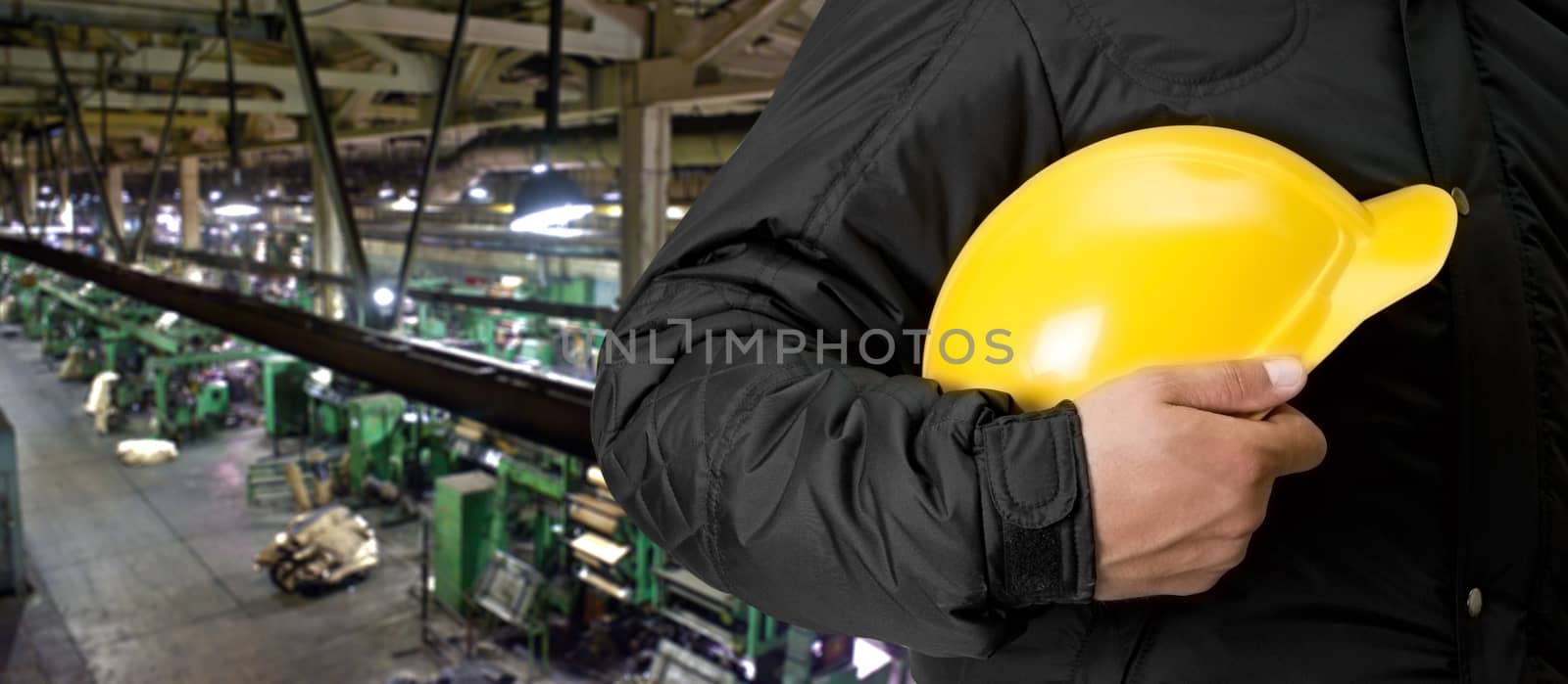 Worker with safety helmet at industrial factory