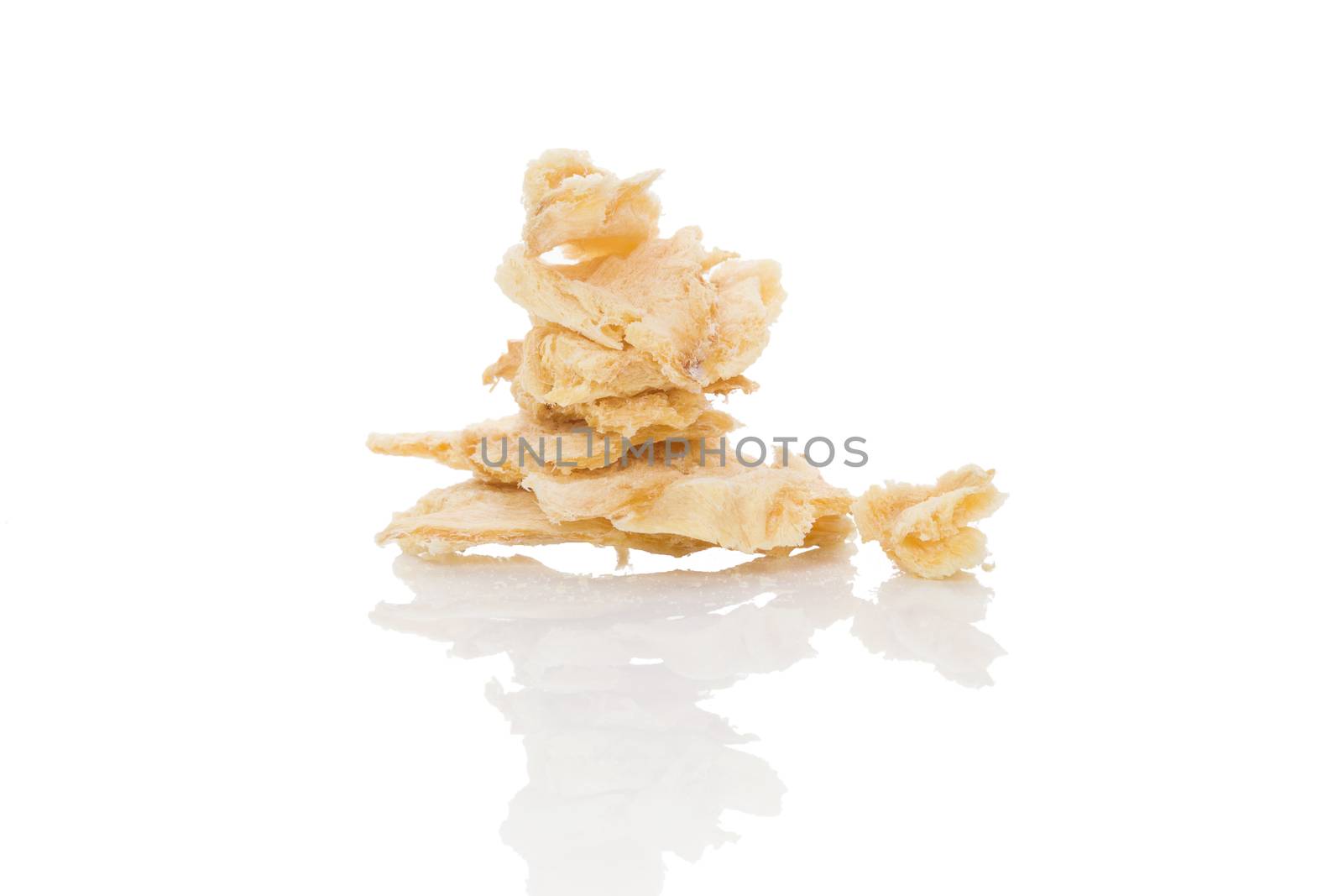 Dried fish pieces isolated on white background. Healthy traditional seafood snack.