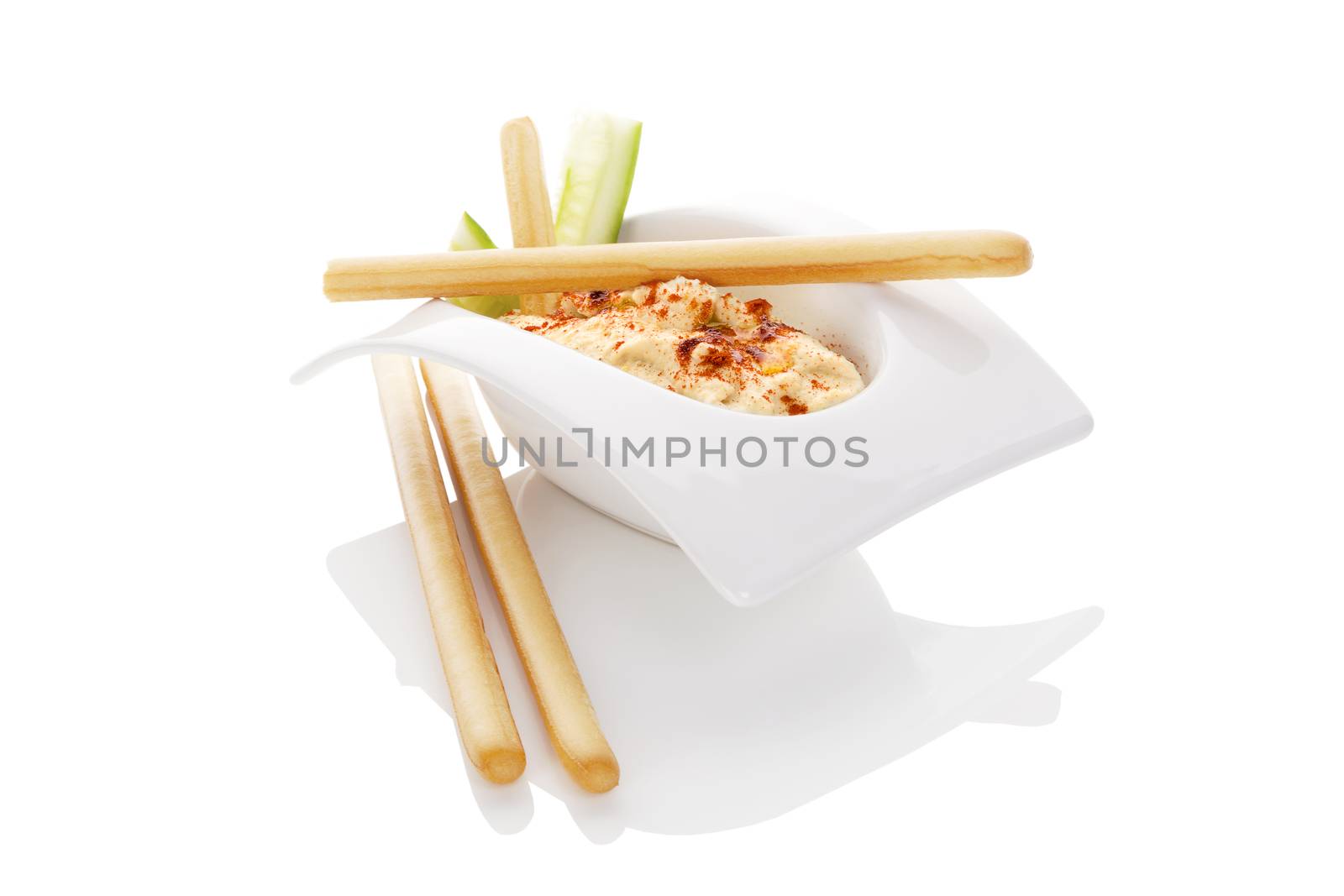 Hummus in white bowl isolate on white background. Minimal contemporary style. Culinary eastern cuisine.