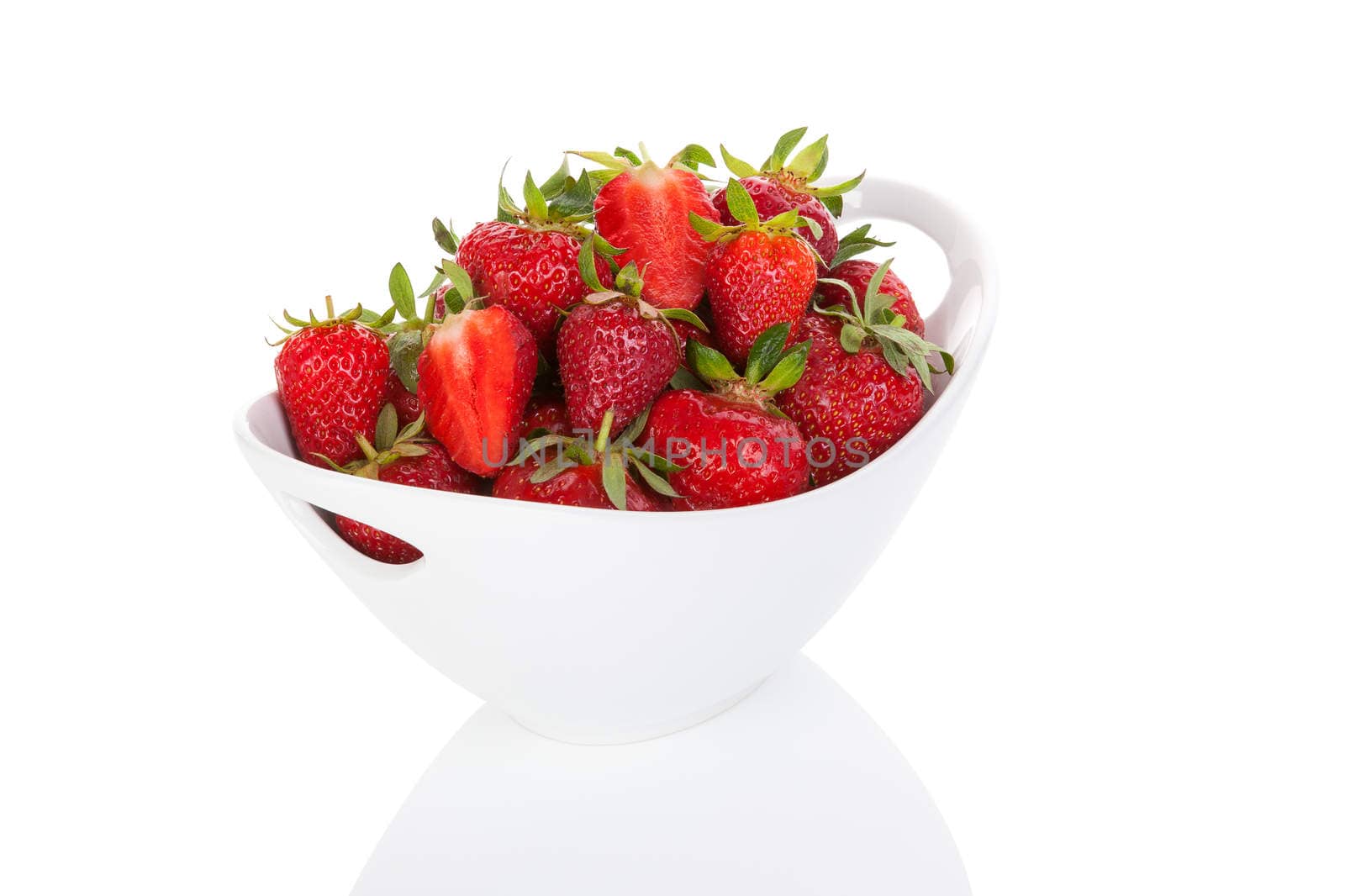 Strawberries in bowl isolated over white. by eskymaks