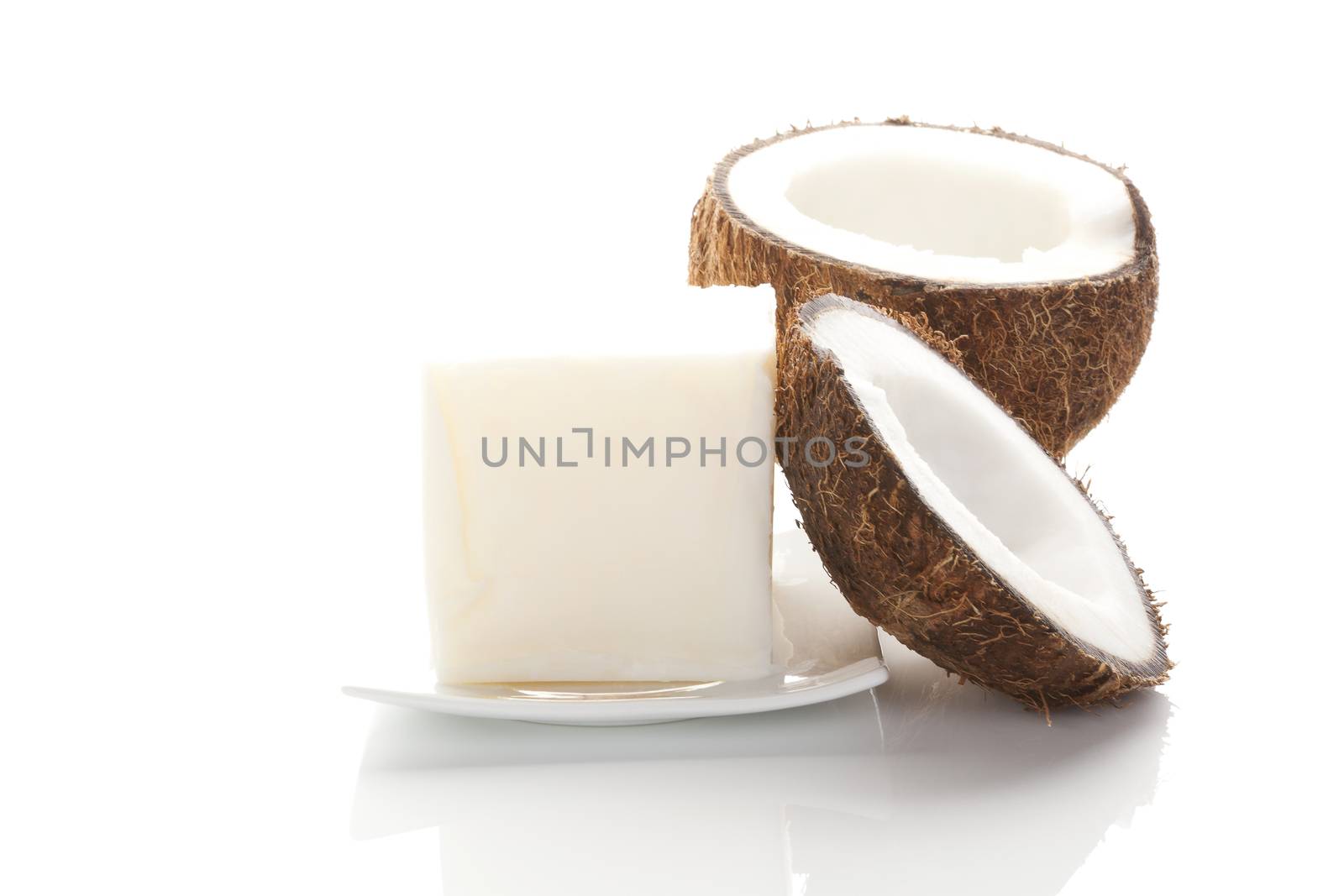 Coconut oil. Hard coconut oil and coconut isolated on white background with reflection. Healthy eating and cooking. 
