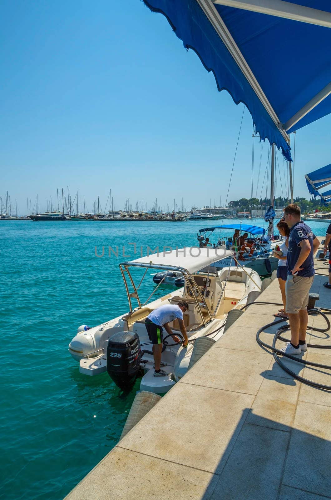 SPLIT, CROATIA - 19 JUL 2015: Boat refuels at a petrol station for ships and boats at the port