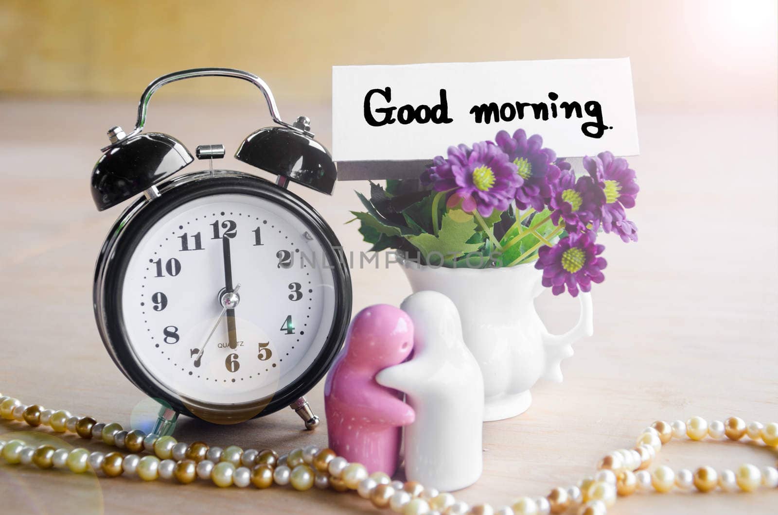 Flowers in a ceramic pots with purple vintage alarm clock. by Gamjai