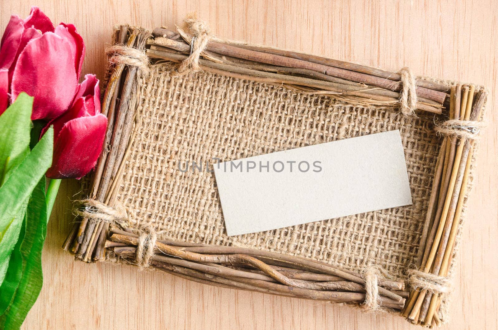 Tulips with a card on a wooden background