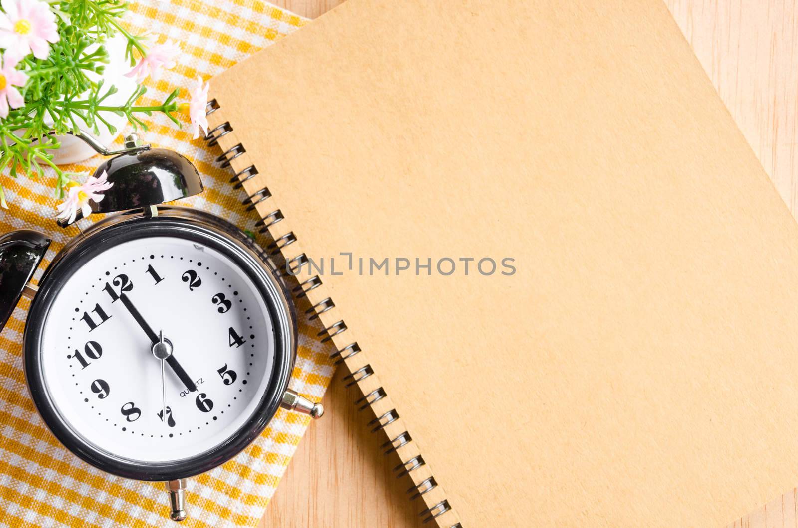 Time management concept: vintage alarm clock, and notepad