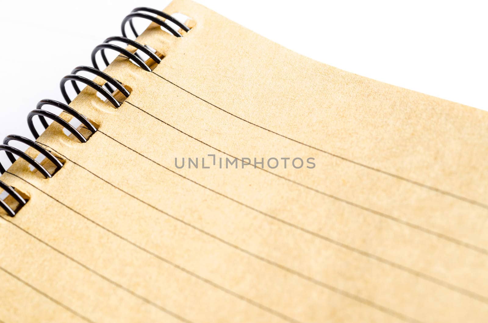 Close up of lined paper in brown diary made from paper recycle. by Gamjai
