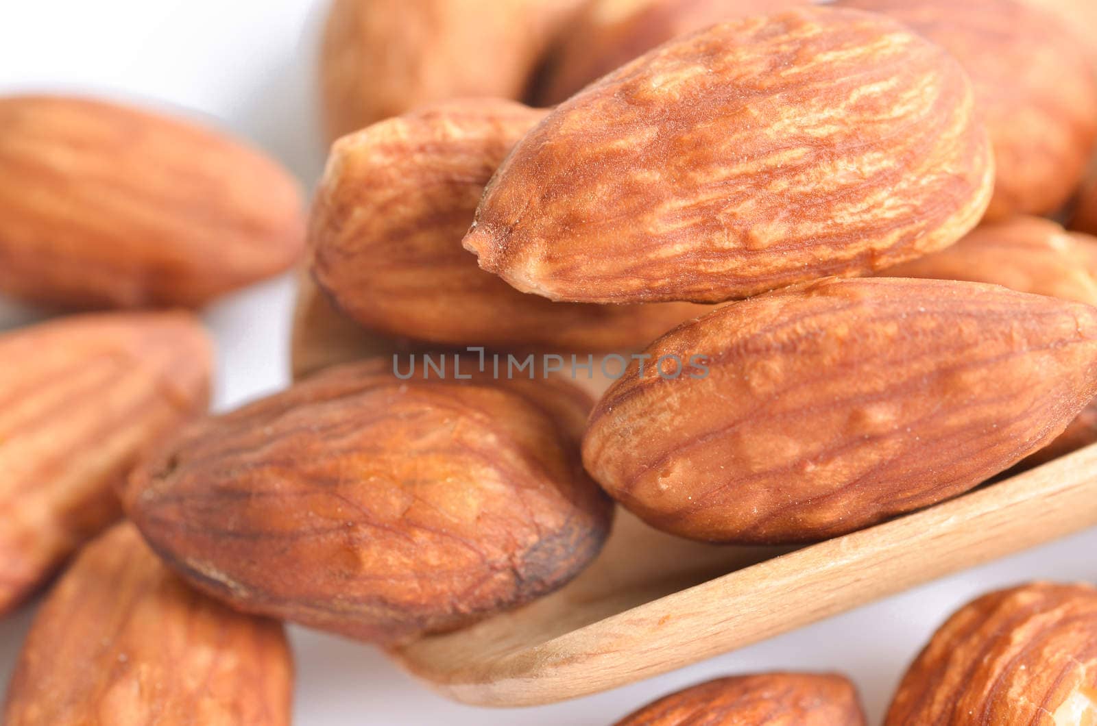 close up almond on white background. by Gamjai