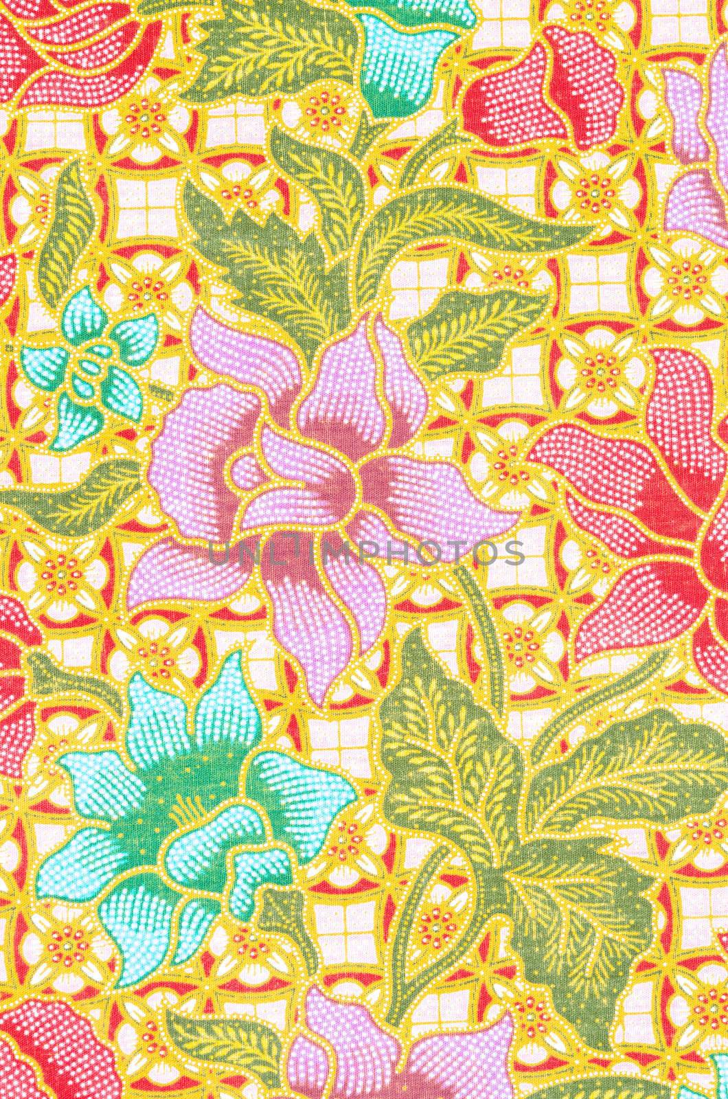 flower pattern background on batik fabric. by Gamjai
