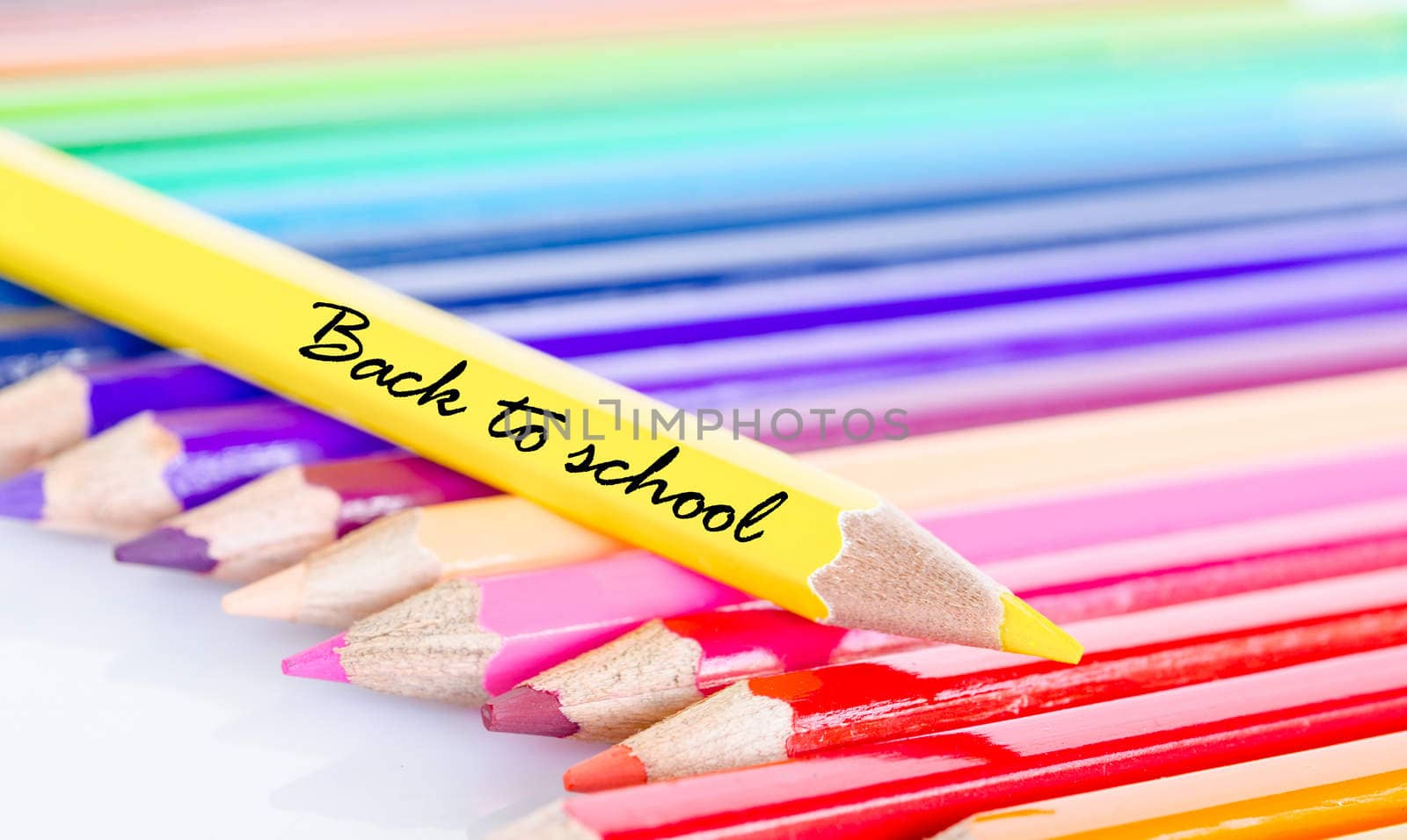 Colorful pencil crayons on a white background. by Gamjai