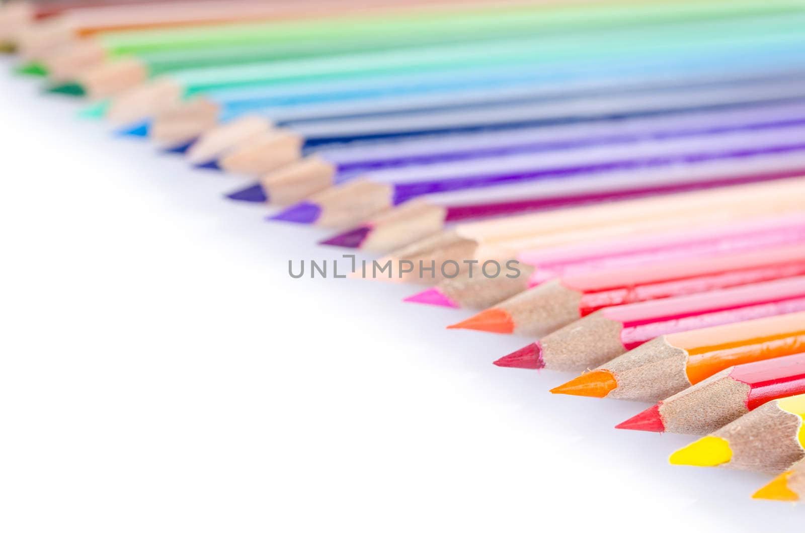line of colored pencils close up.