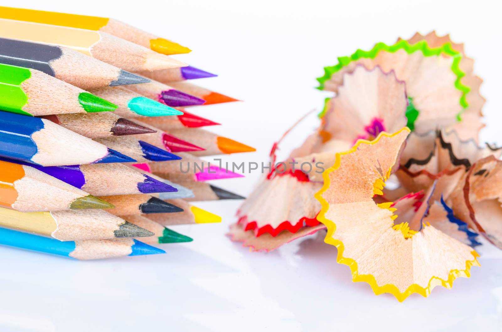 Colored pencil with colorful pencil shavings on white background