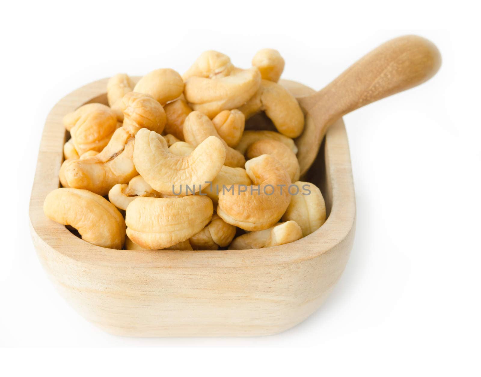 Cashew nuts in wooden bowl on white background.