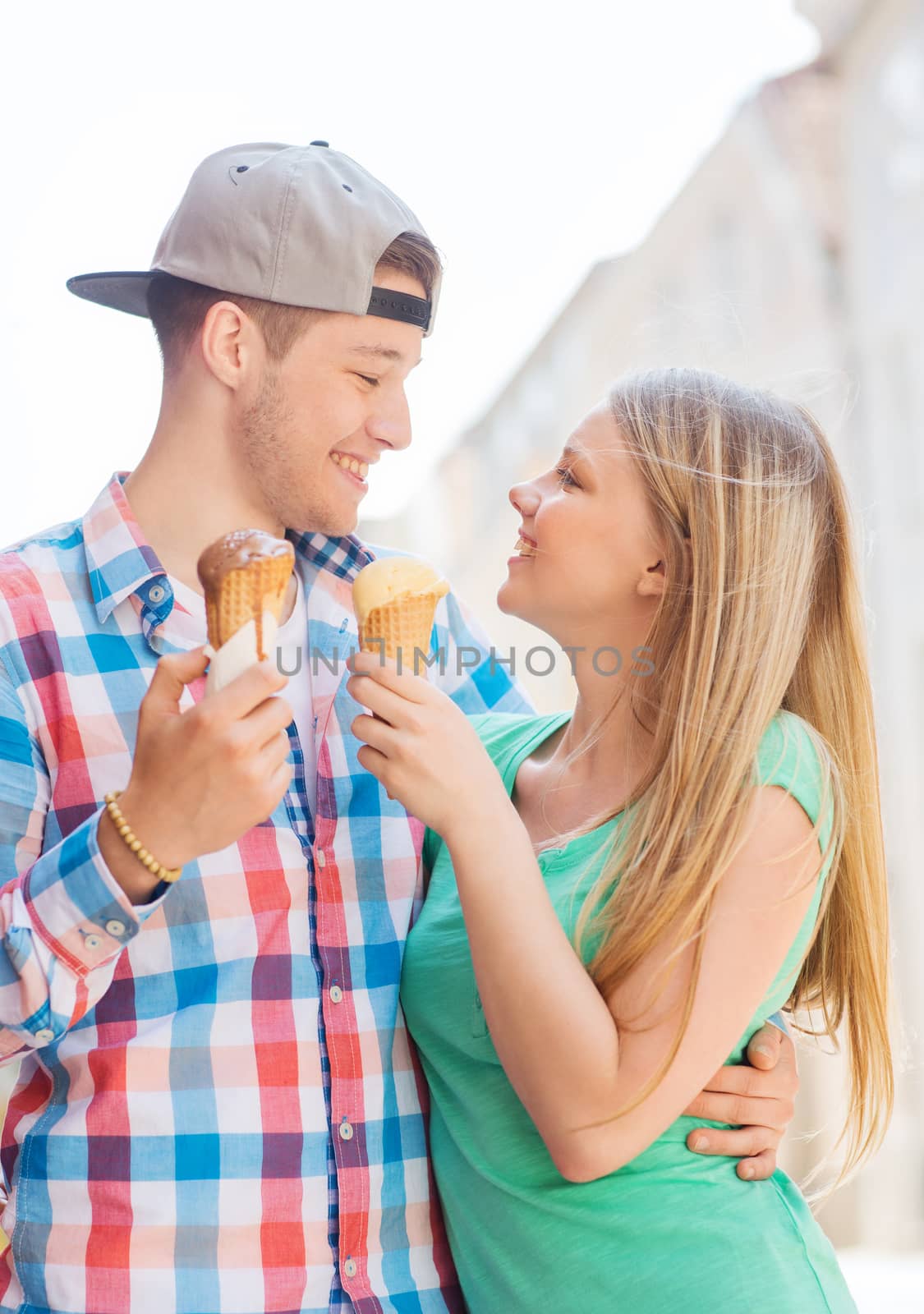 smiling couple with ice-cream in city by dolgachov