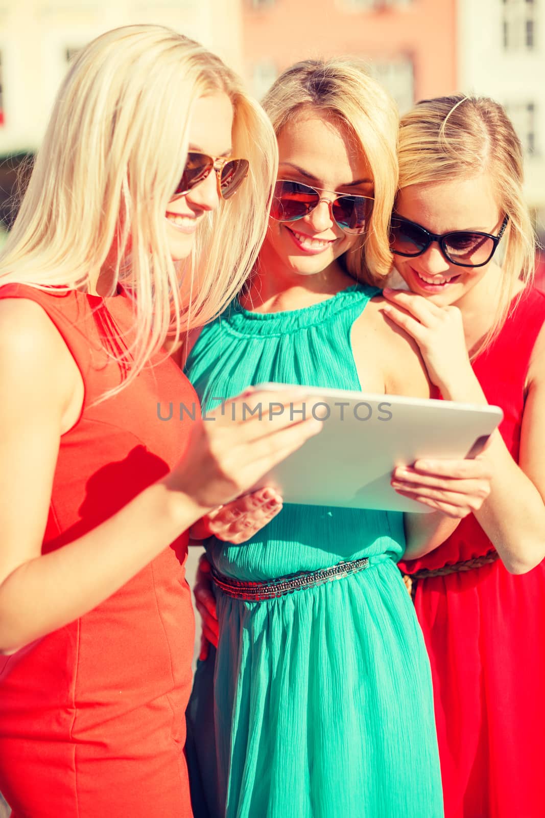 beautiful girls toursits looking into tablet pc by dolgachov