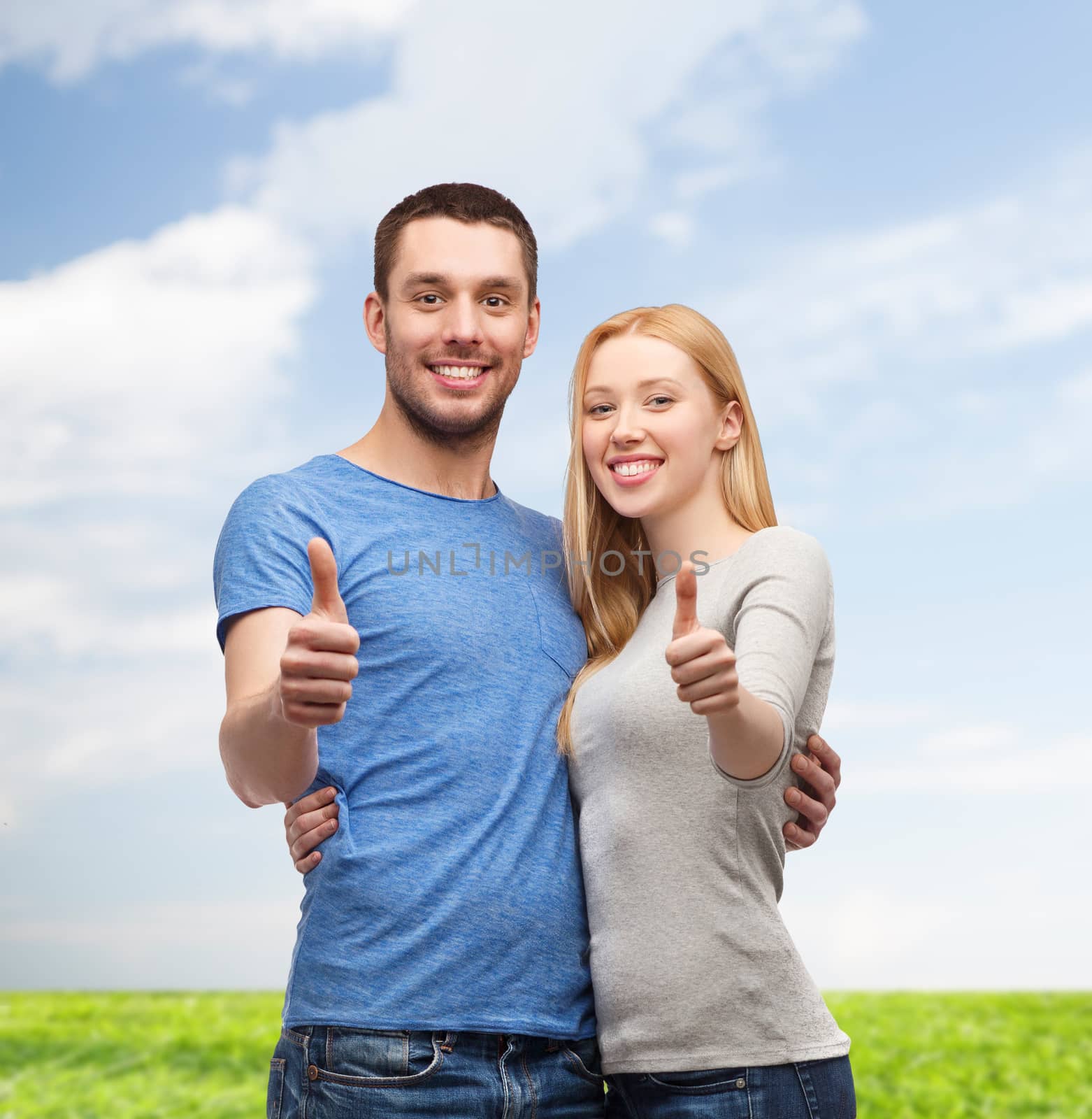 smiling couple showing thumbs up by dolgachov