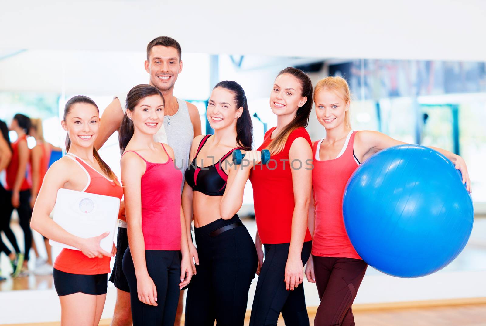 group of smiling people in the gym by dolgachov