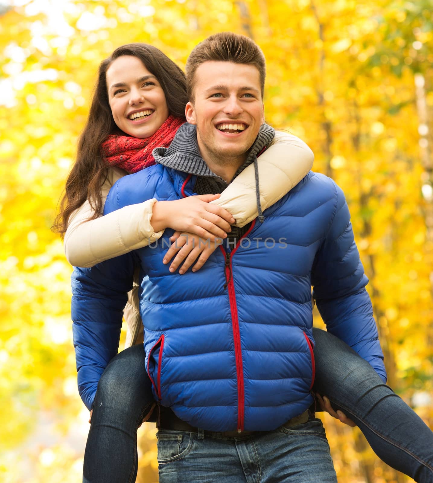 smiling friends having fun in autumn park by dolgachov