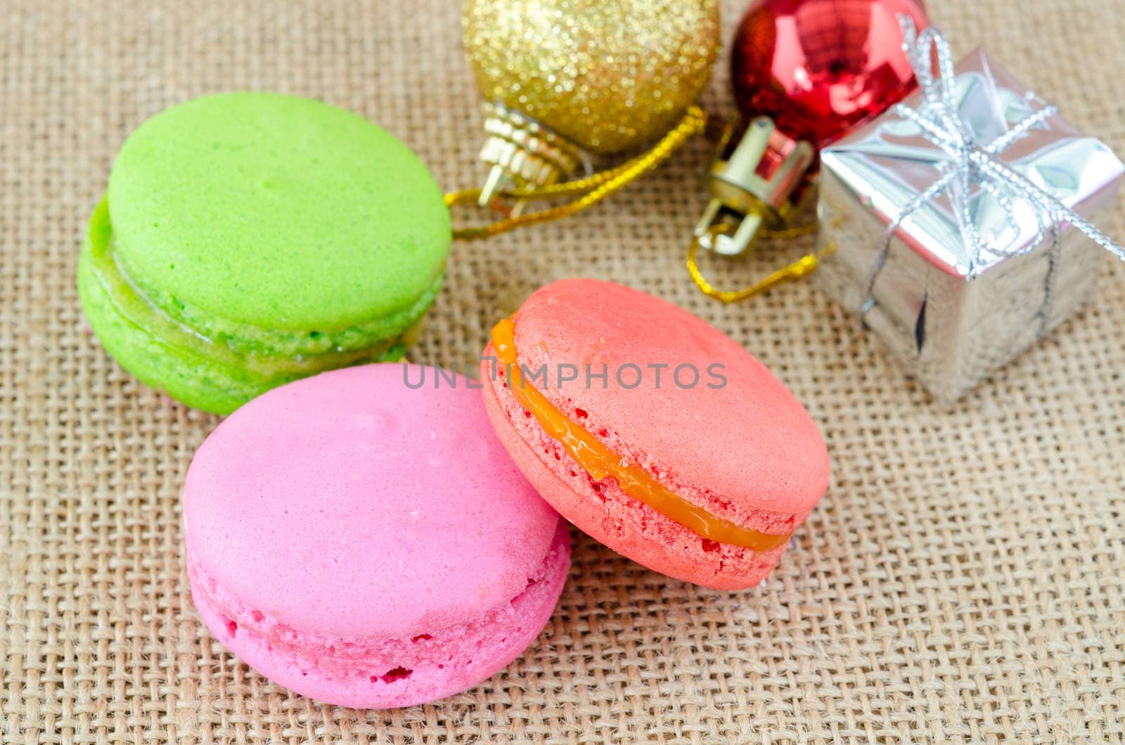 French macaroons on sack background. by Gamjai