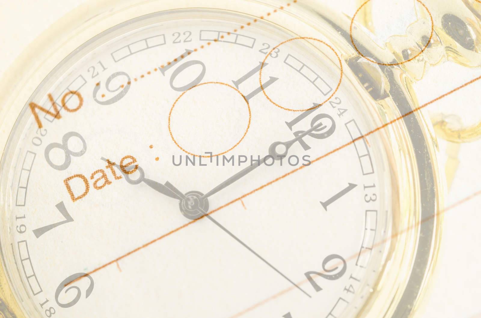 Time Business Concept. Gold pocket watch and close up diary background.