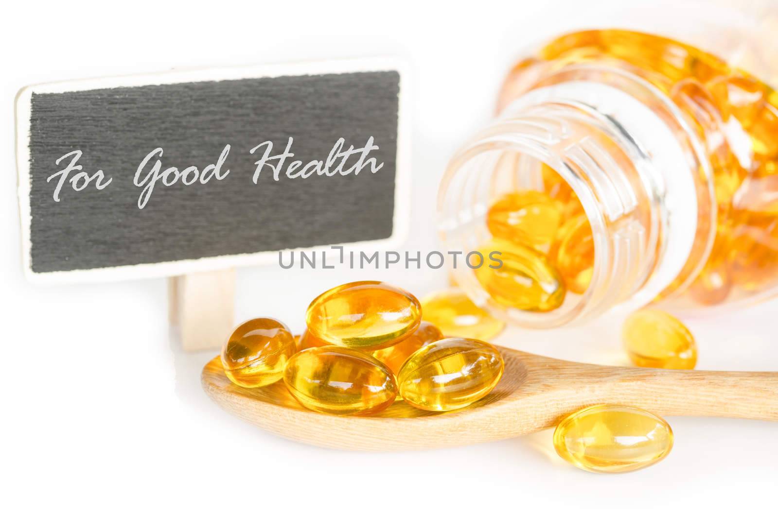 Cod liver oil omega 3 gel capsules and For good health tag on white background.
