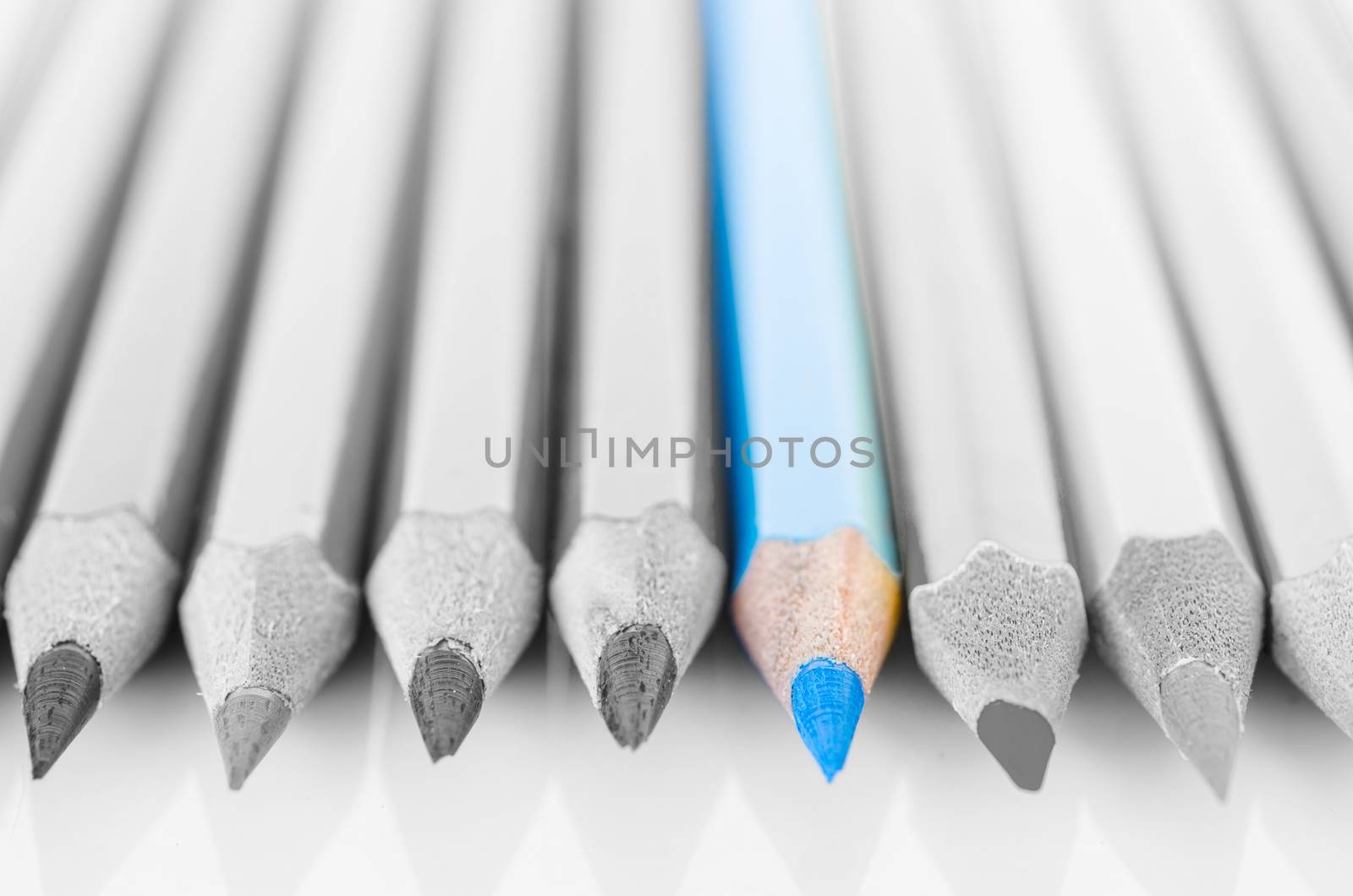 Focus at blue colored pencil with no colored pencil on white background.