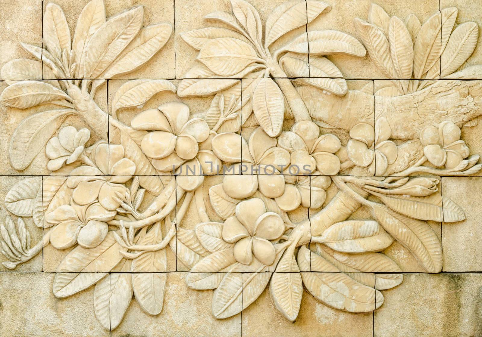 Low relief cement Thai style handcraft of plumeria or frangipani flowers