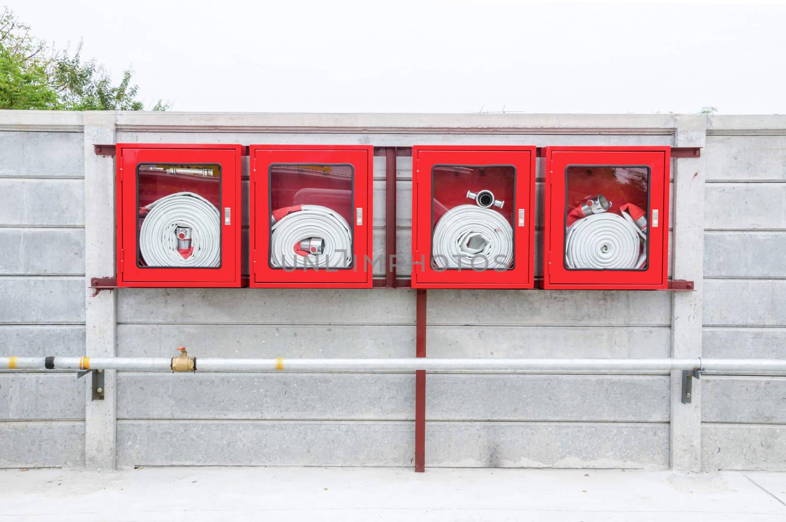 Red Fire Hose Cabinet on wall.