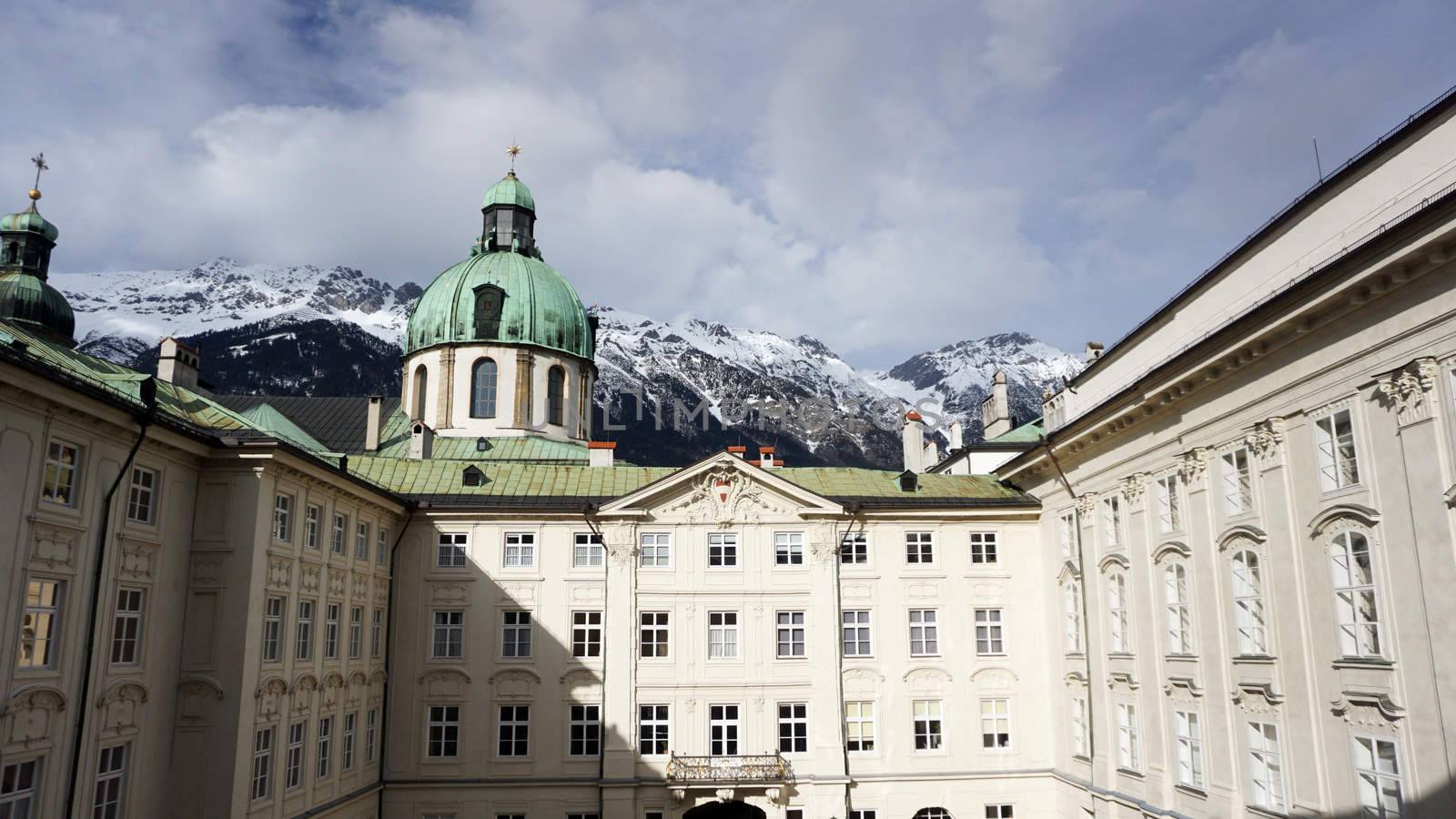 hofburg palace with snow mountains background by polarbearstudio