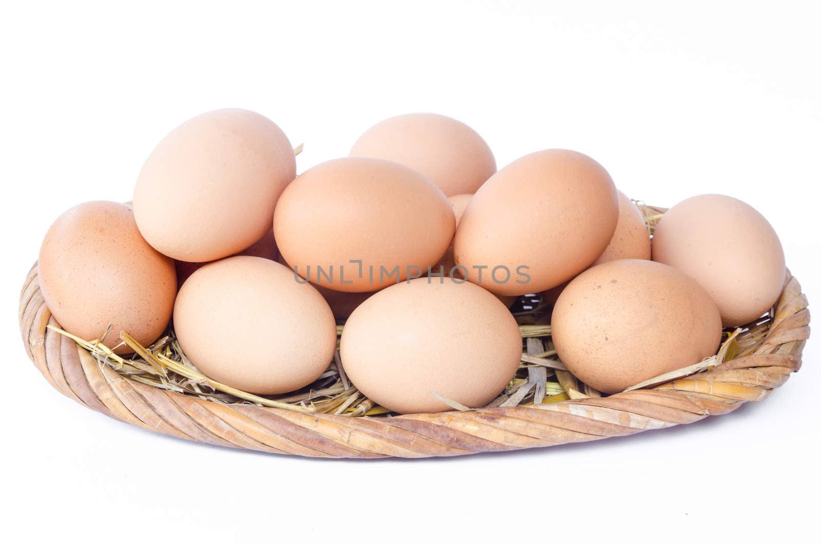 Eggs in weave basket on white background.