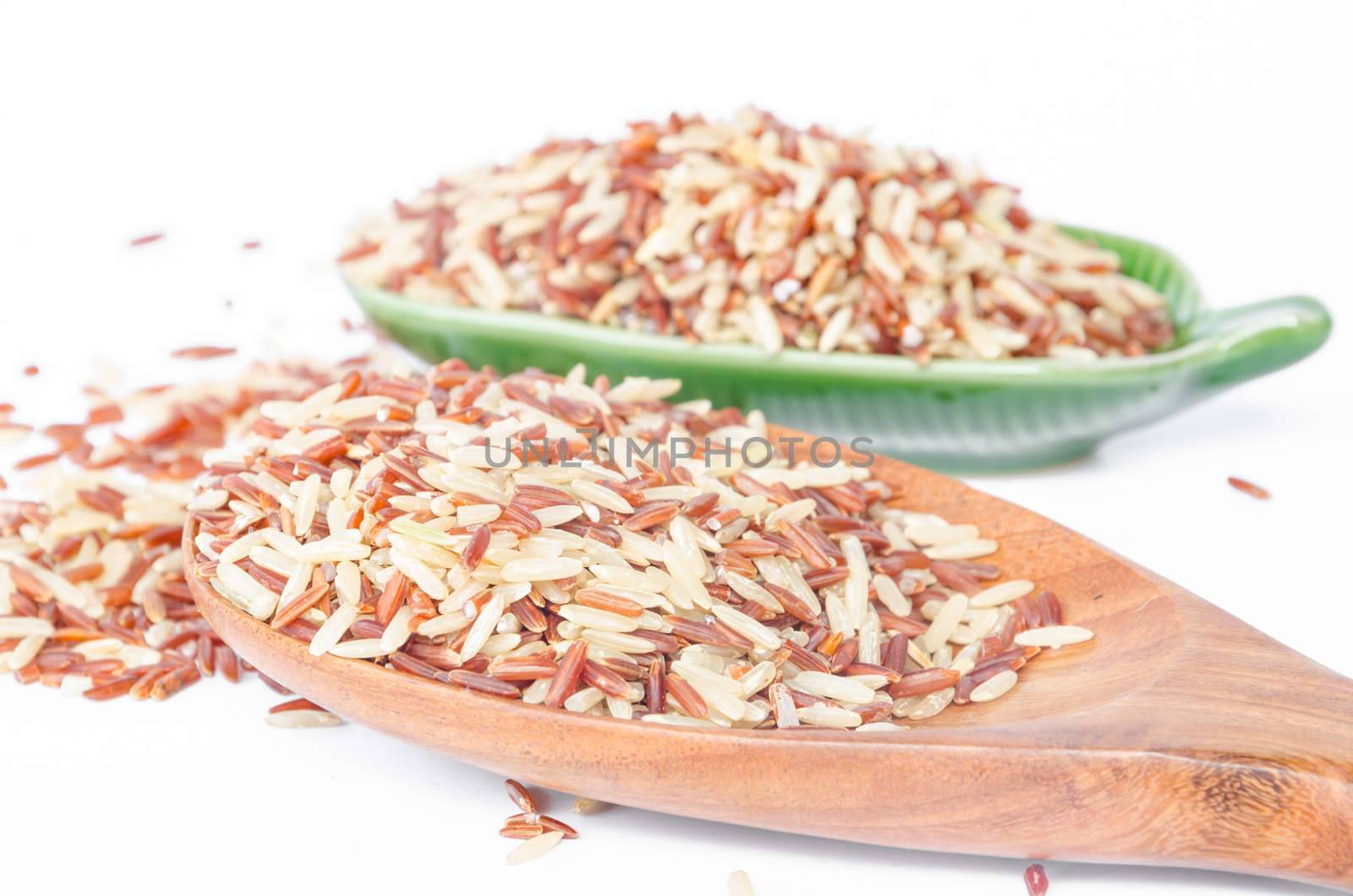 brown rice in a wooden spoon