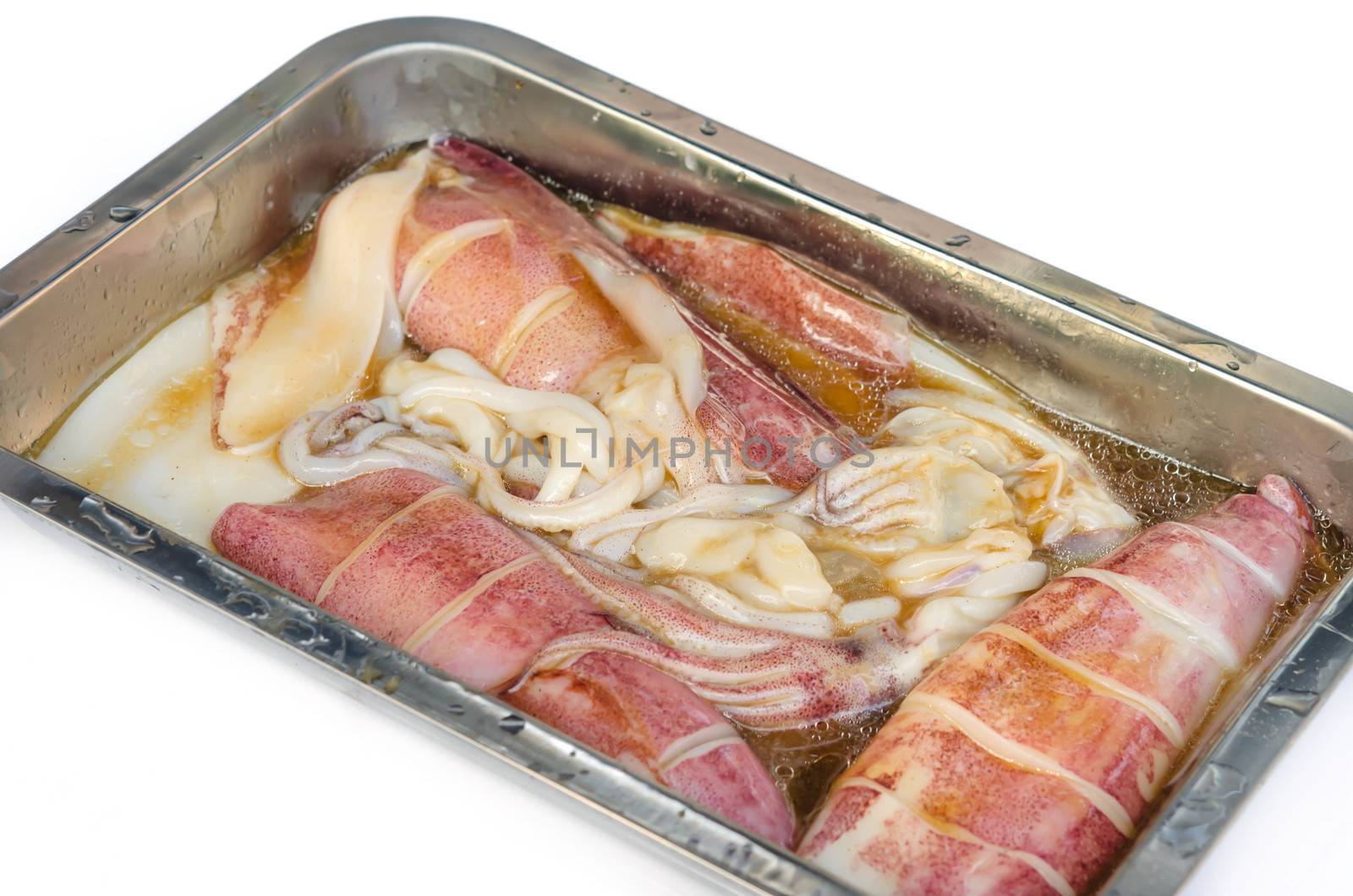 Preparation of raw squid and ingredients , ready to grill
