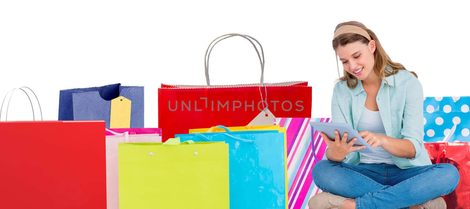 Pretty hipster using tablet pc  against white background with vignette