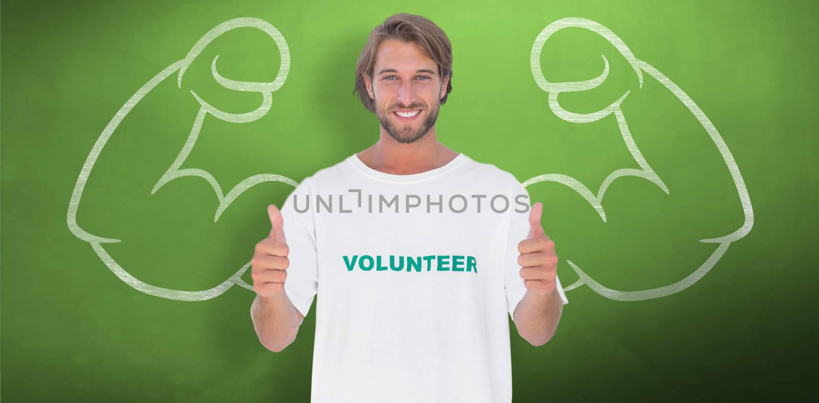 Happy man wearing volunteer tshirt giving thumbs up against green chalkboard