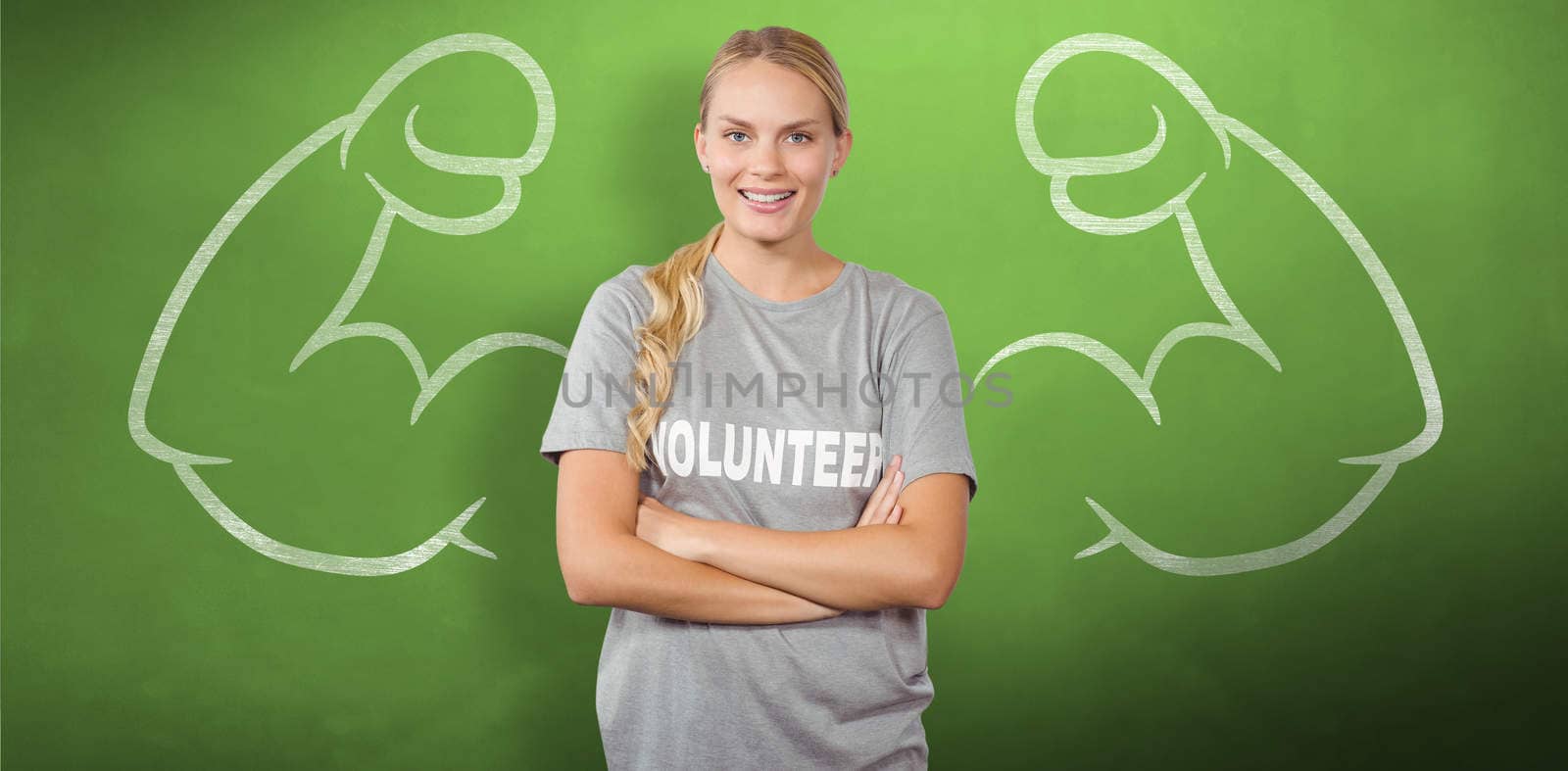 Portrait of beautiful smiling woman with arms crossed  against green chalkboard