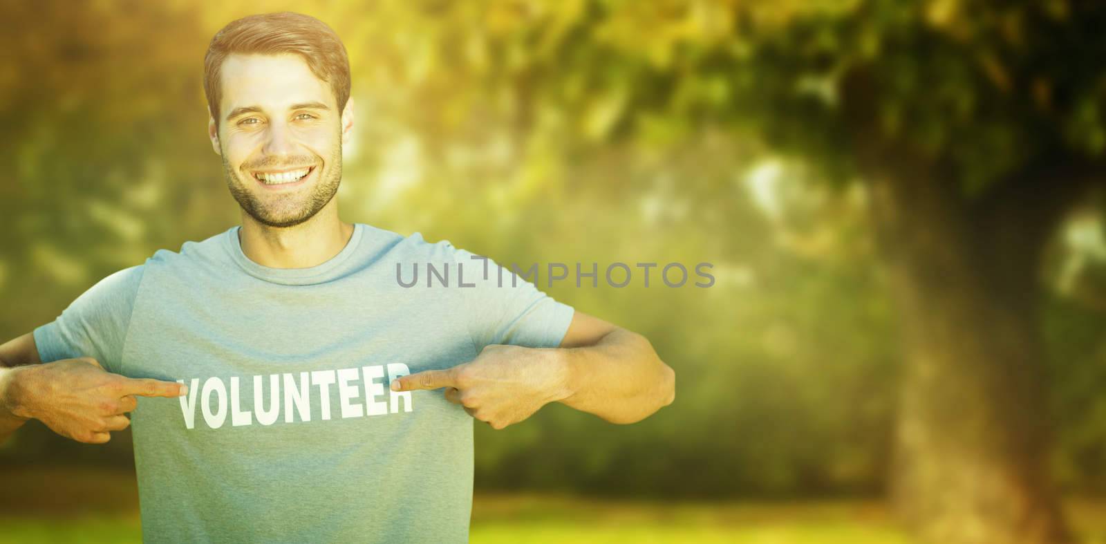 Happy volunteer in the park against trees and meadow in the park
