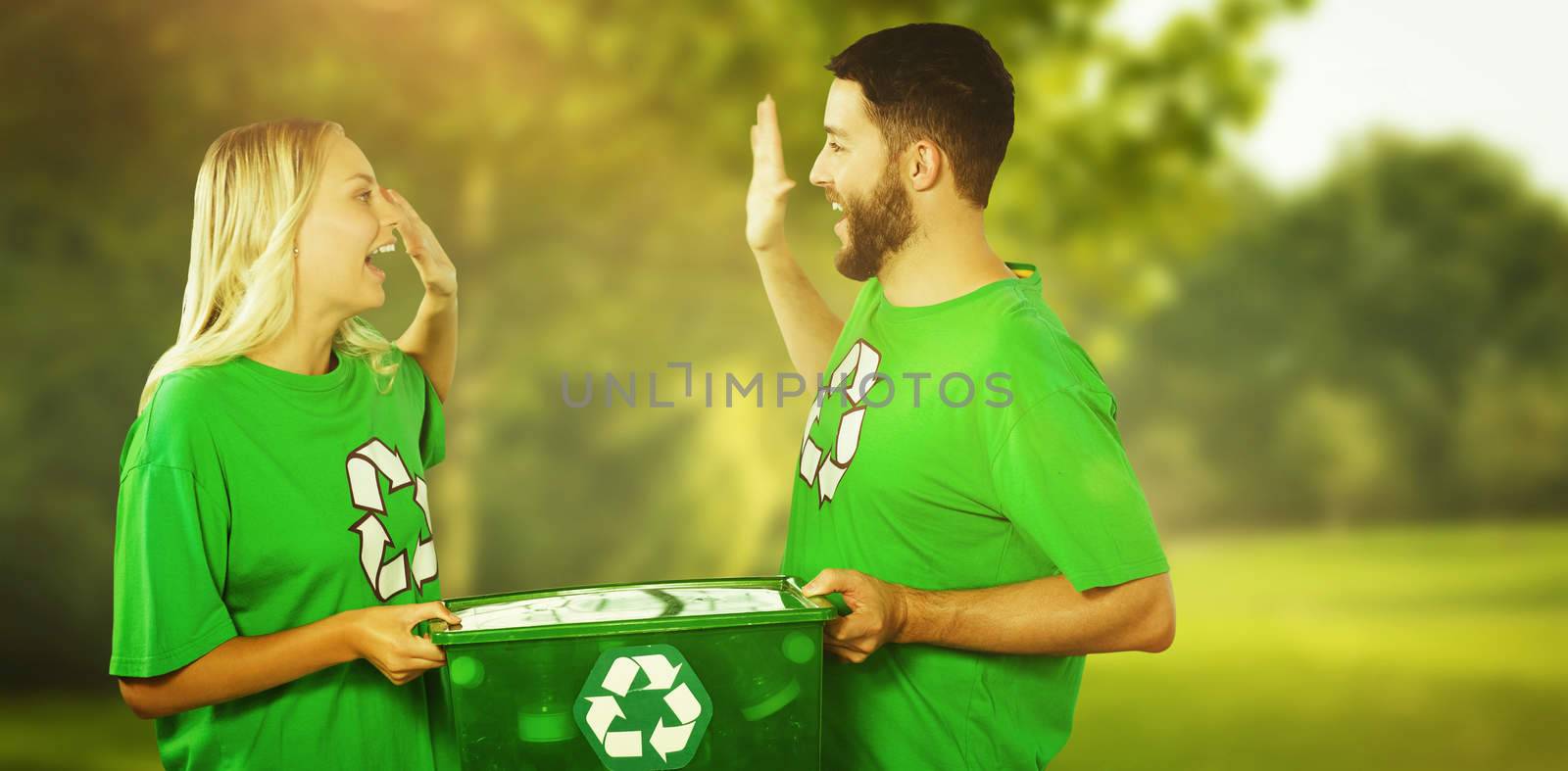 Composite image of smiling volunteer doing high five while holding container  by Wavebreakmedia