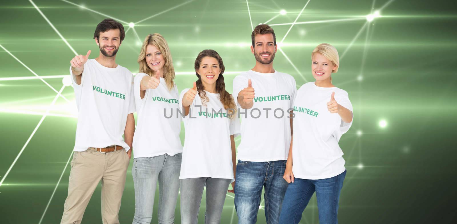 Group portrait of happy volunteers gesturing thumbs up against glowing geometric design