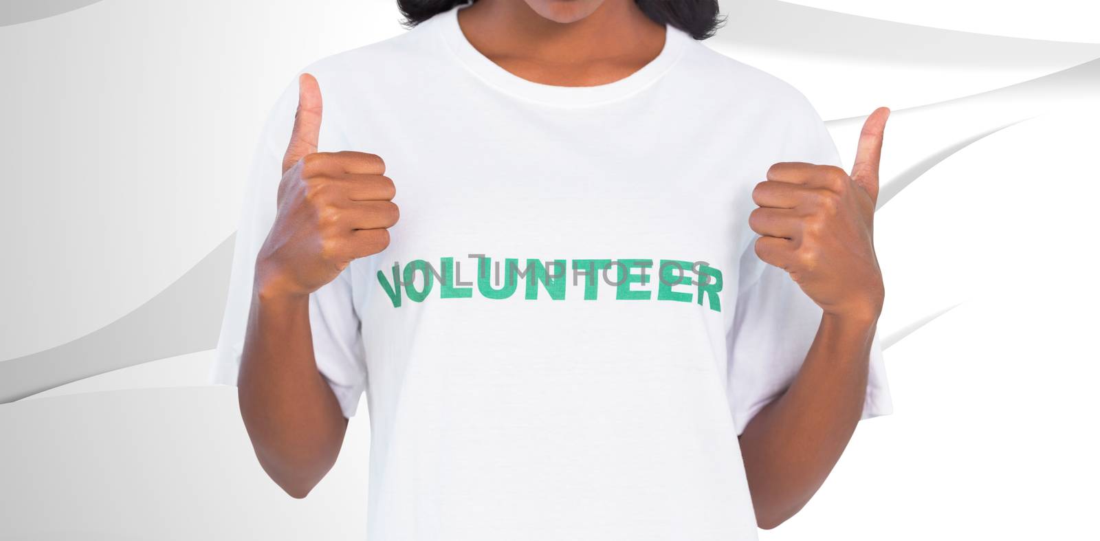 Composite image of woman wearing volunteer tshirt and giving thumbs up by Wavebreakmedia