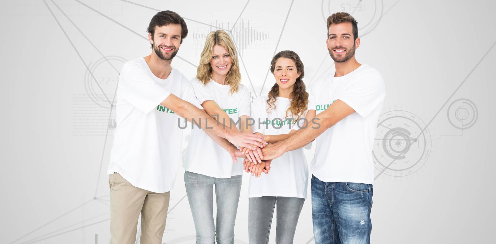 Group portrait of happy volunteers with hands together against interface with graphs