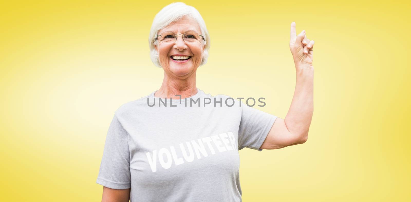 Happy volunteer grandmother with thumbs up  against yellow vignette