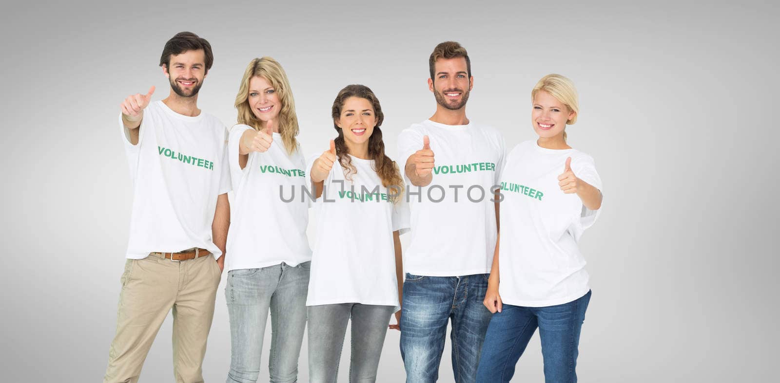 Composite image of group portrait of happy volunteers gesturing thumbs up by Wavebreakmedia