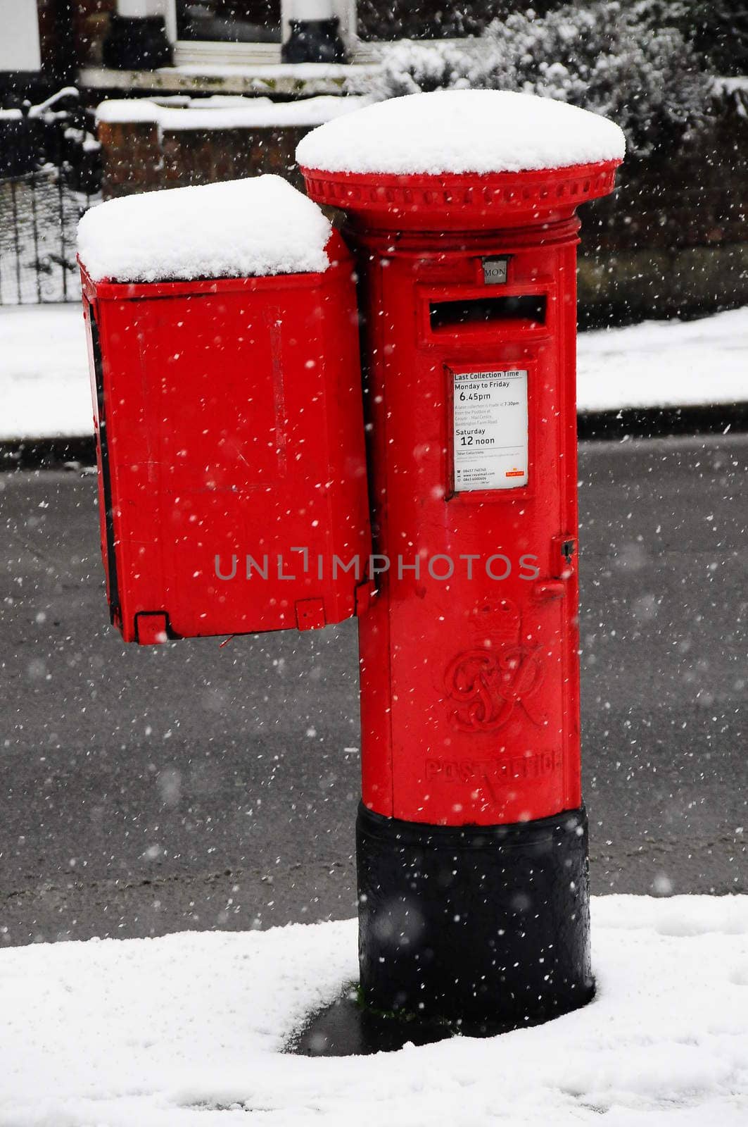 London pillar box in snowstorm