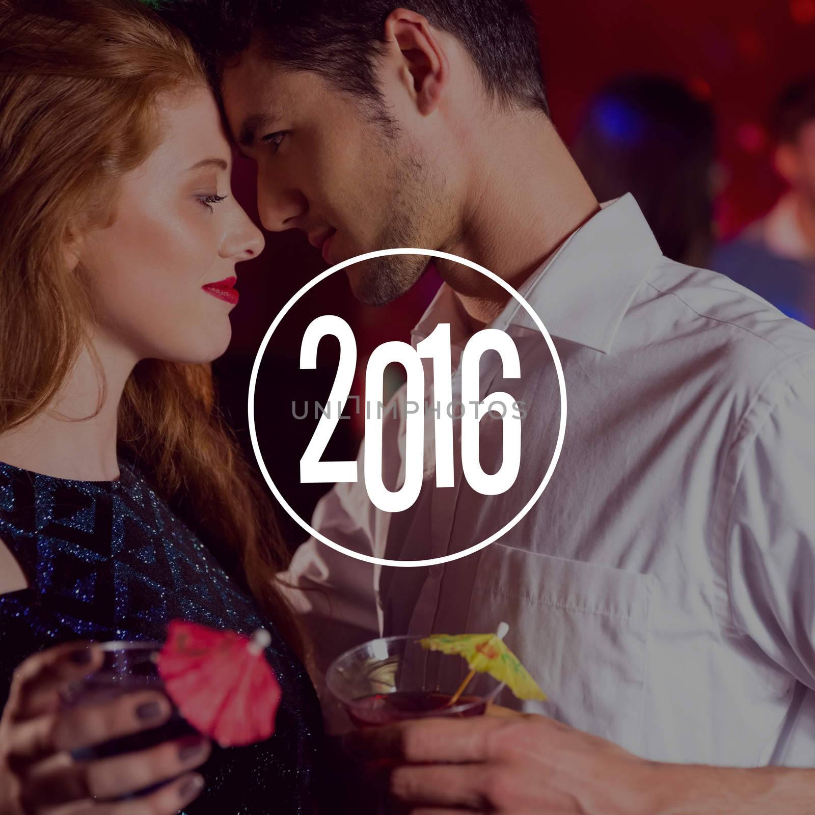 New year graphic against cute couple drinking cocktails together