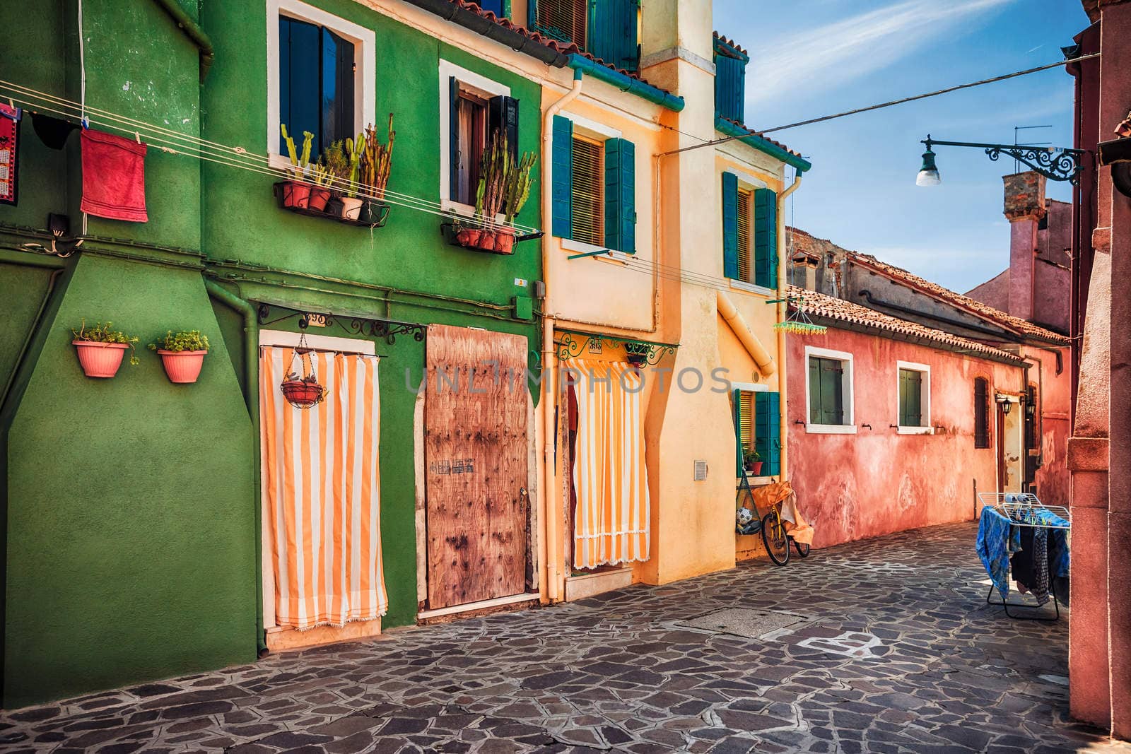 Colourfully painted house facade with windows on Burano island, province of Venice, Italy