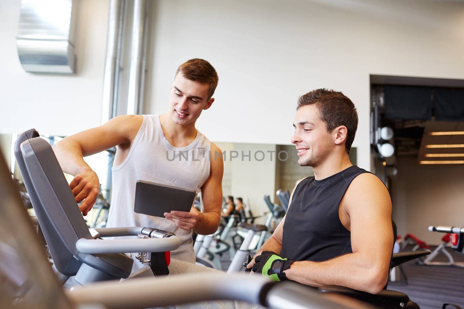 men exercising on gym machine by dolgachov