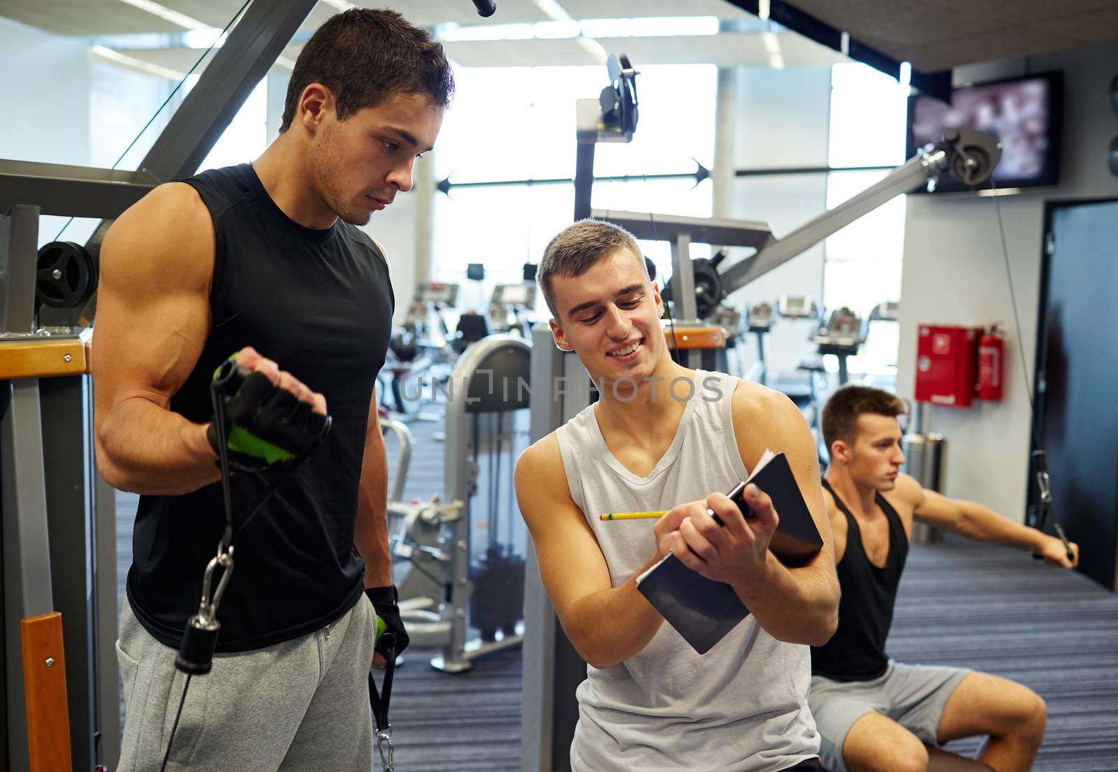 men exercising on gym machine by dolgachov
